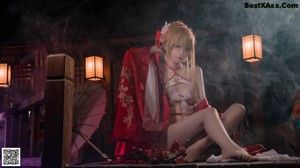 A woman in a red and white lingerie posing for a picture.