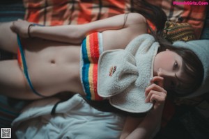 A woman in a bikini and a hat posing for a picture.