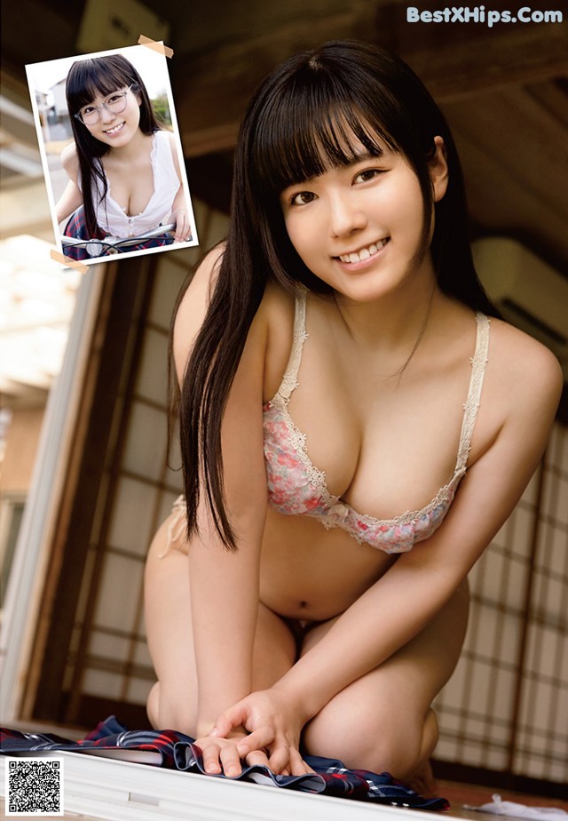 A young woman in a bra and panties posing for a picture.