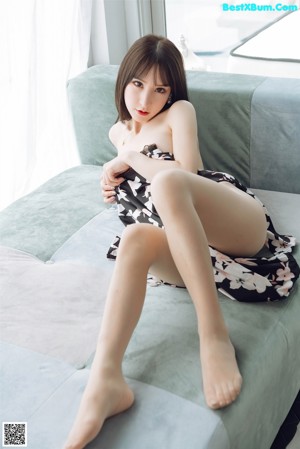 a woman sitting on top of a blue couch