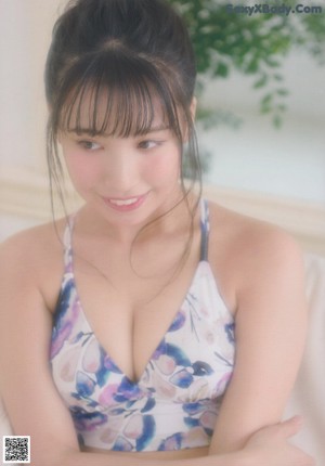 A woman sitting on a wooden chair in a bikini.