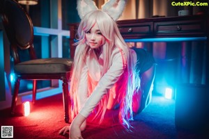 A woman in a bunny costume sitting at a desk.