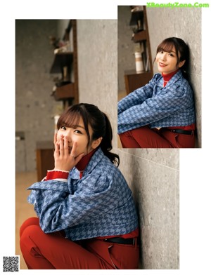 A woman sitting on the floor in pajamas and a white shirt.