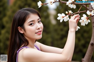 A naked asian woman sitting on top of a wooden table.