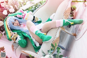 A woman in a bunny costume sitting on a white rug.