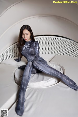 A woman in a wet suit posing in a pool.