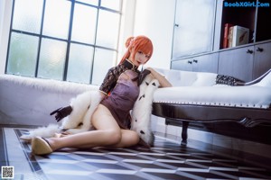 A woman sitting on top of a white couch.