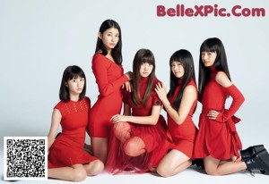 A group of girls in red dresses posing for a magazine.