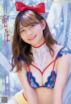 A woman in a blue dress and white gloves posing for a picture.