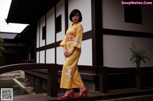 A woman in a yellow bikini standing on a set of stairs.