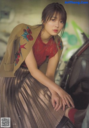A magazine spread with a picture of a woman sitting on a train.